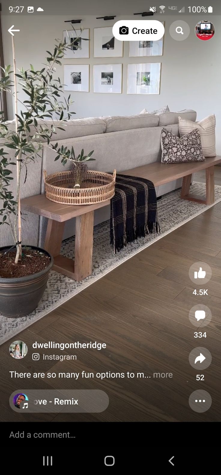 a living room with a couch, table and potted plant on the floor in front of it