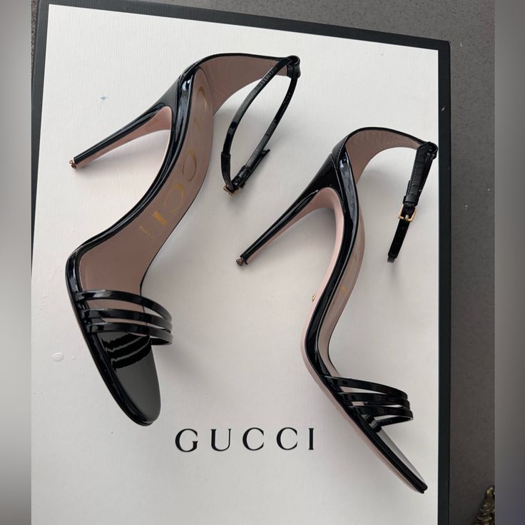 A Classic Silhouette, The Heeled Sandal Is Presented For The Latest Gucci Collection In Shiny Patent Leather. Ankle Closure With Adjustable Buckle And Leather Sole. Had Taps Replaced For More Stability. (New Taps Included With Heel) 3in Heel. Gucci Designer Sandals With Single Toe Strap, Designer Gucci Sandals With Single Toe Strap, Designer Patent Leather Heels With Single Toe Strap, Chic Gucci Sandals With Single Toe Strap, Gucci Open Toe Heels With 4-inch Heel, Gucci Ankle Strap Sandals For Formal Occasions, Elegant Gucci Sandals For Evening, Classic Open Heel Sandals For Party, Chic Gucci High Heels