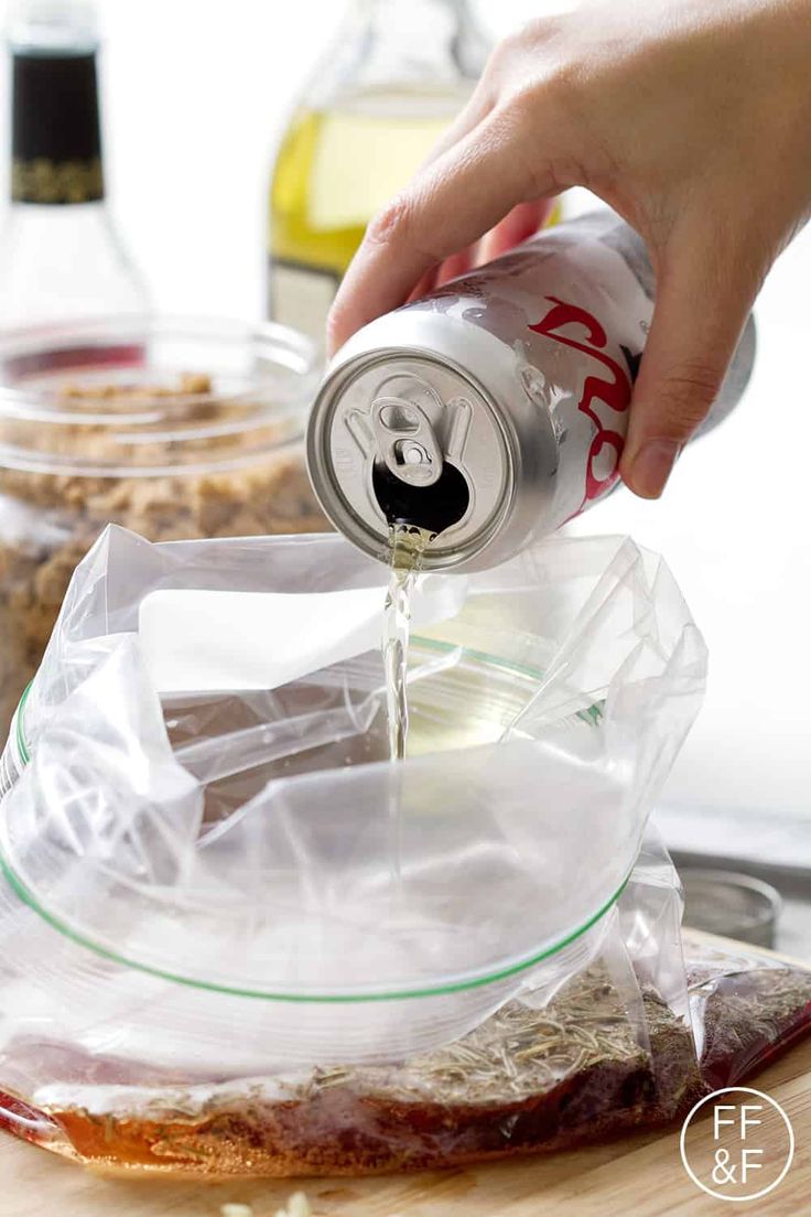 a person is pouring something into a can