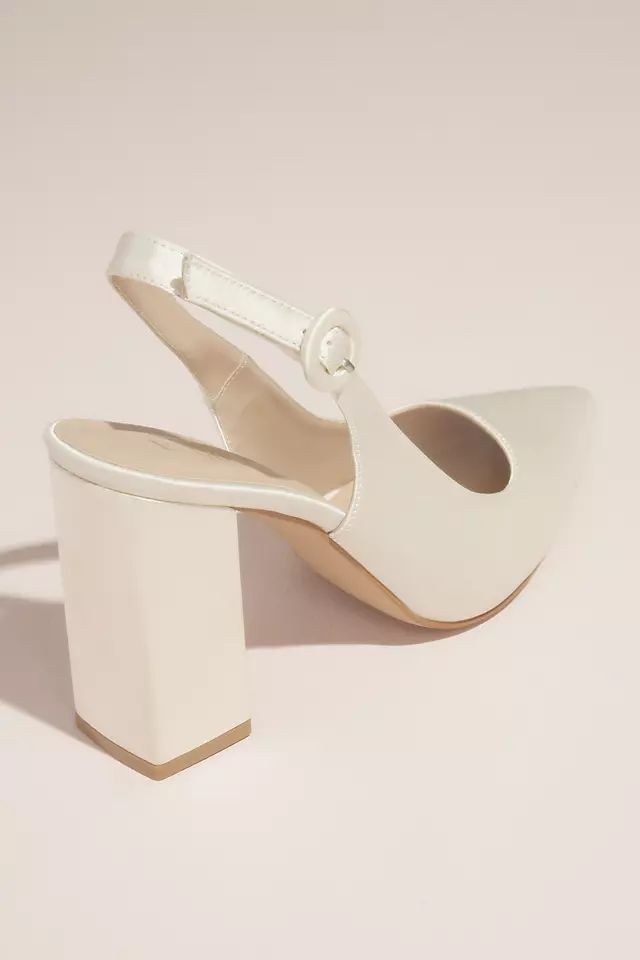 a pair of white high heeled shoes