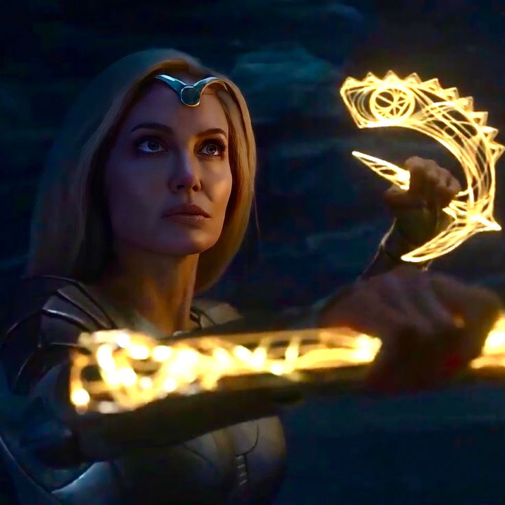 a woman holding a glowing object in her hand