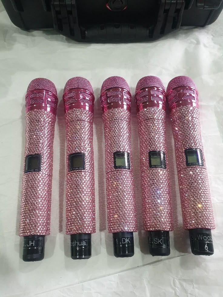 four pink microphones sitting next to each other