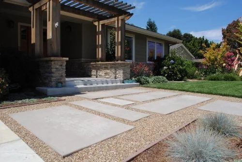 a house with landscaping in the front yard and walkway leading up to it's entrance