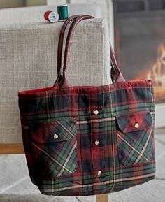 a plaid bag sitting on top of a chair