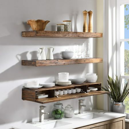 two wooden shelves with dishes and cups on them in front of a window next to a sink