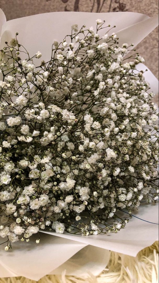 a bouquet of white flowers sitting on top of a table