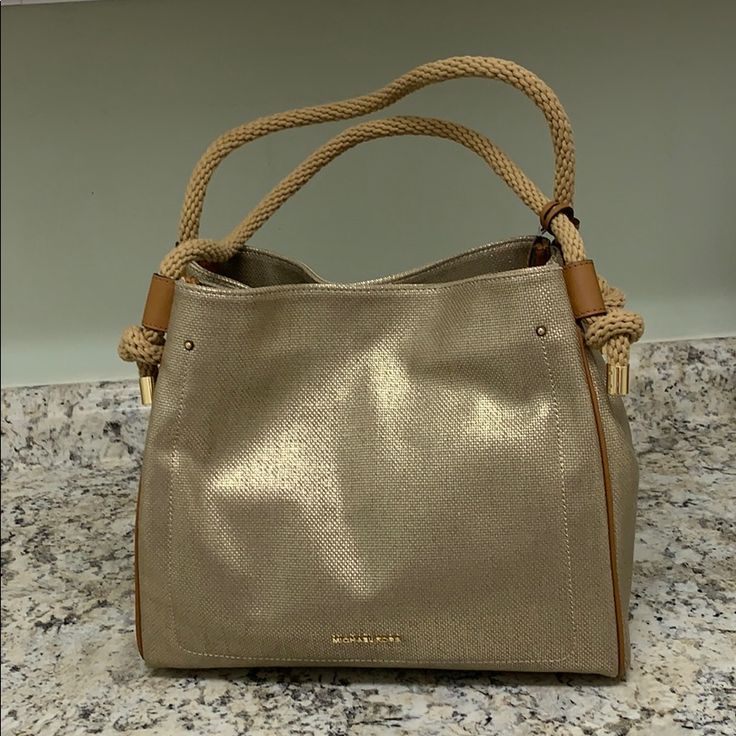 Brand New Gold And Tan Handbag. Very Neutral And Perfect For All Seasons! Straps Can Go Over The Shoulder. 13” Wide 11” High 5 1/2 Inches Deep Gold Hobo Bag With Gold-tone Hardware For Daily Use, Gold Hobo Bag With Gold-tone Hardware For Travel, Gold Hobo Bag With Braided Handles For Everyday Use, Gold Top Handle Shoulder Bag With Leather Handles, Gold Top Handle Bag With Braided Handles, Michael Kors Shoulder Bag With Gold-tone Hardware, Michael Kors Large Capacity Shoulder Bag For Errands, Gold Hobo Shoulder Bag, Michael Kors Shoulder Bag With Double Leather Handles