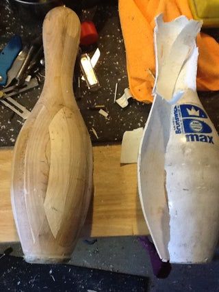 two wooden vases sitting on top of a table next to other tools and materials