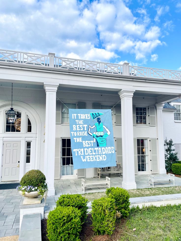 a large white house with a sign on the front