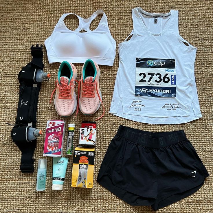 the contents of a woman's running outfit laid out on top of a carpet