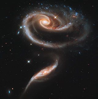 two spiral galaxy like objects in the sky