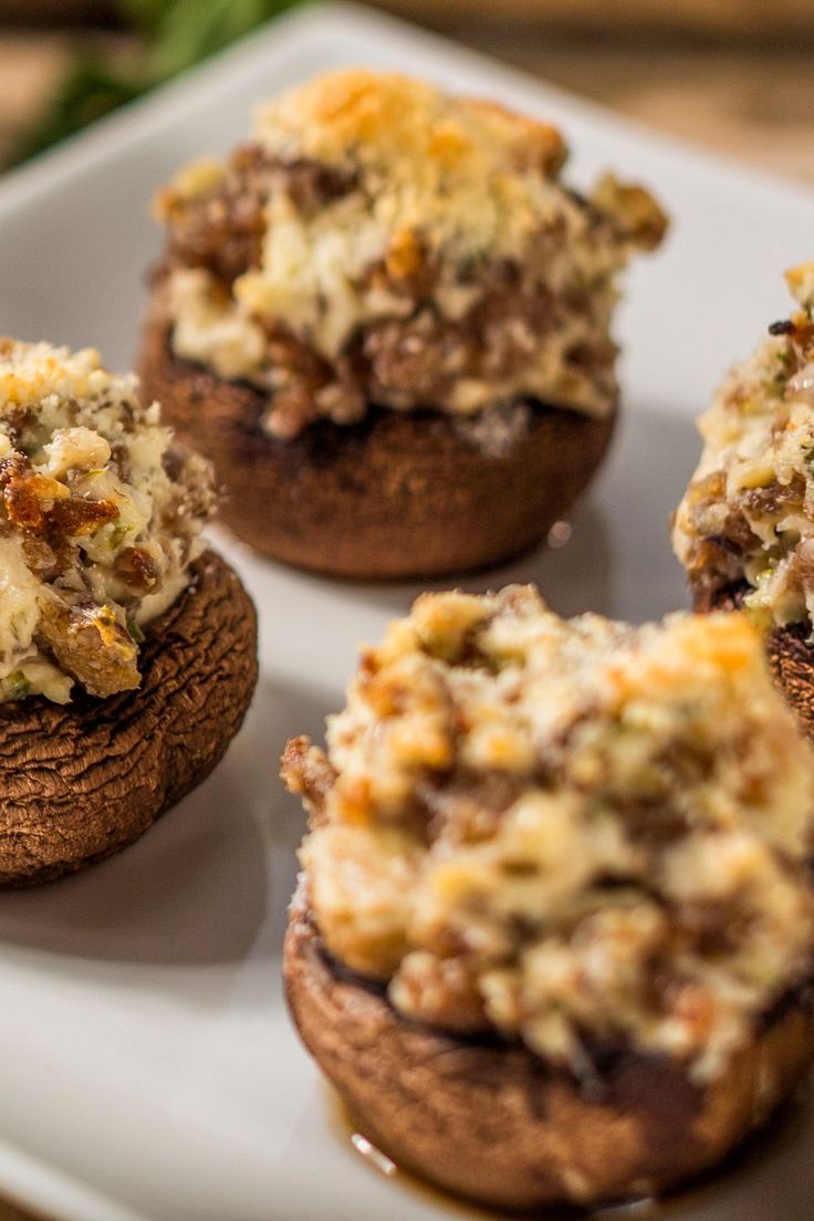 several stuffed mushrooms are on a white plate