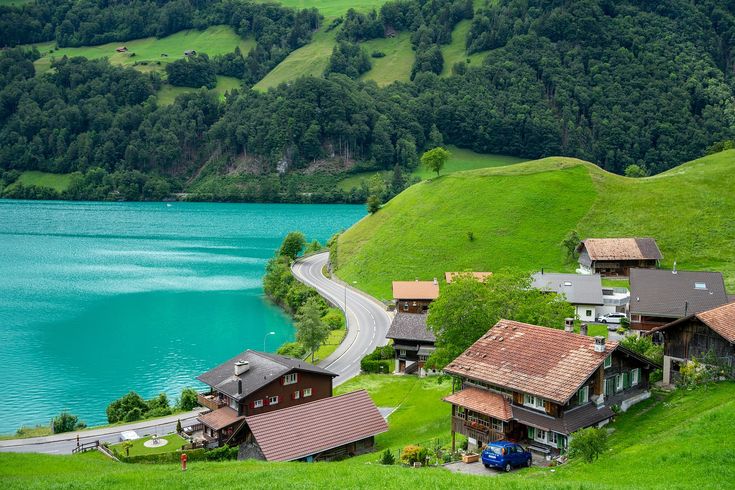 a lake surrounded by lush green hills and trees