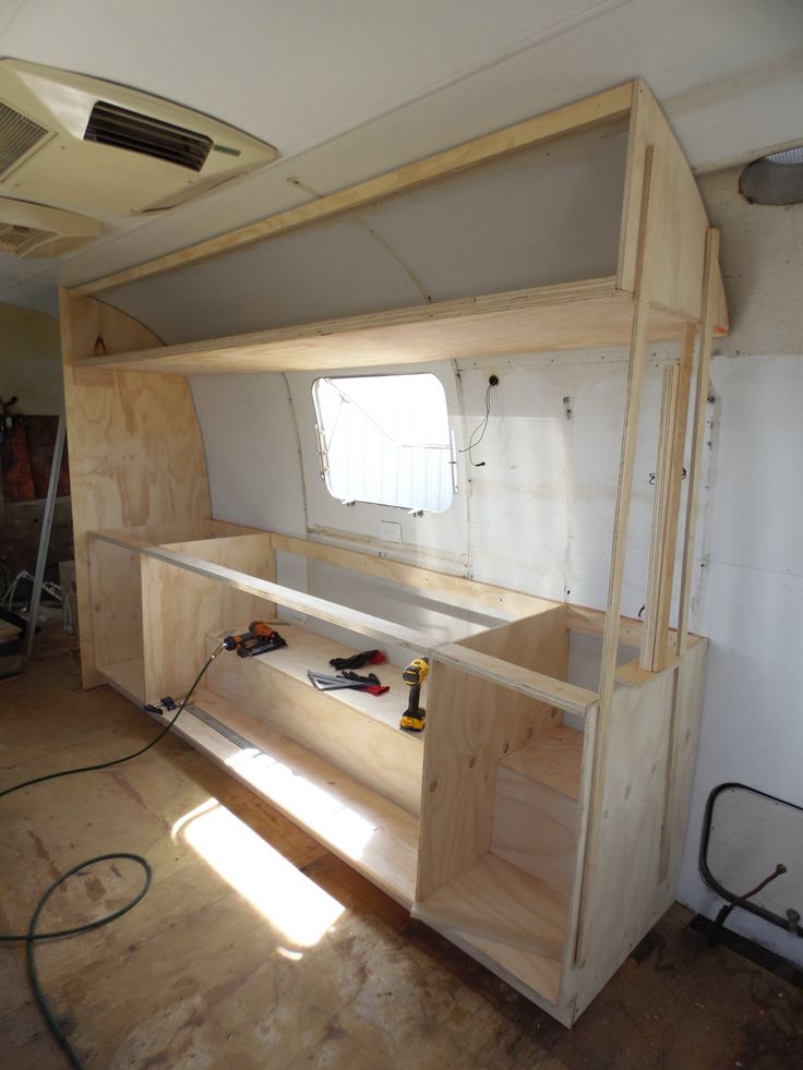 the inside of an rv is being built with plywood and other woodworking tools