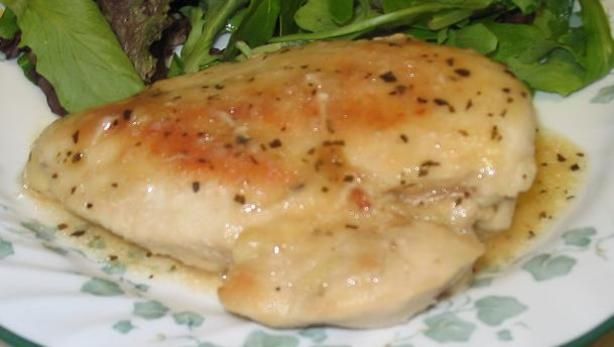 a white plate topped with chicken and greens