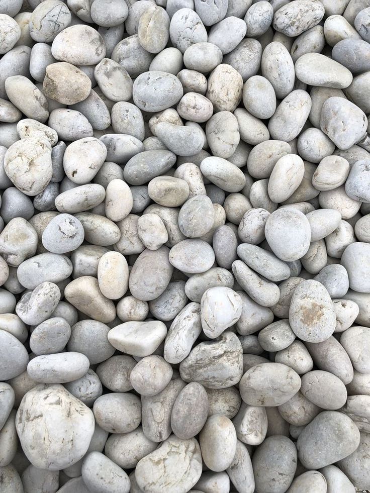 some white rocks are stacked together on top of each other in the middle of a pile