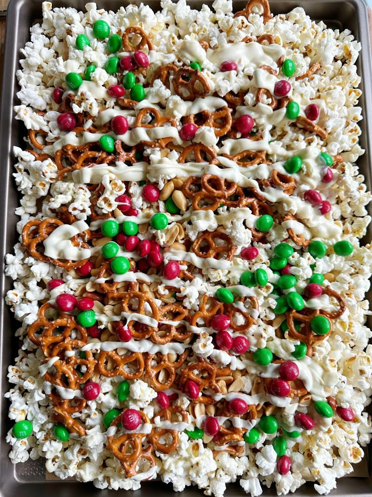 a tray filled with rice krispy kreme treats and pretzels on top