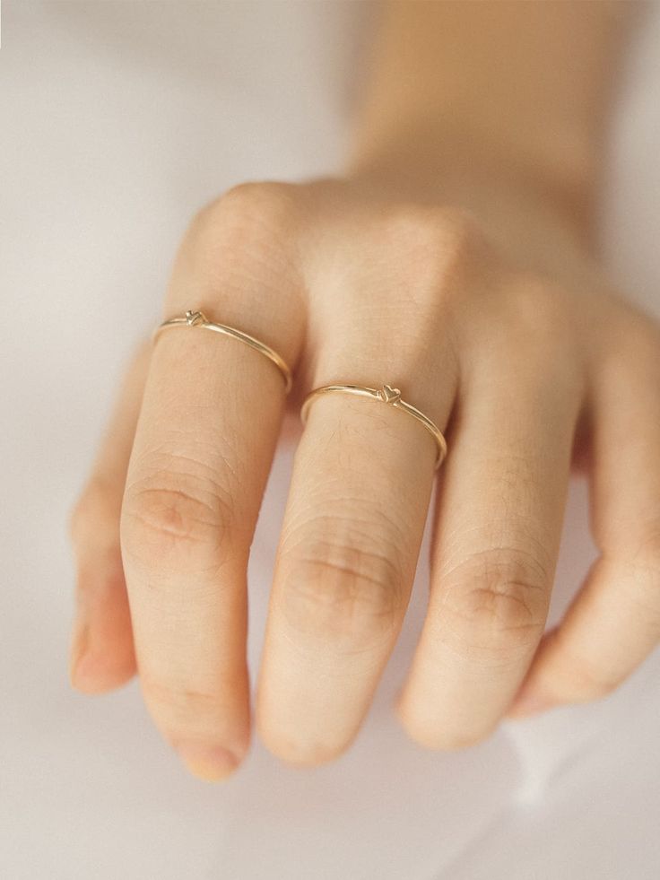 Don't wear your heart on your sleeve - wear it on your finger, shh..it's our little secret. Our Teeny Tiny Heart Ring is handcrafted in solid 14K gold in 1.15 mm width, lightweight and durable. Minimalist Stackable Heart Ring For Promise, Minimalist 14k Gold Initial Ring For Promise, 14k Gold Stackable Rings With Single Diamond For Everyday, Dainty Tiny Heart Ring For Everyday, Dainty Heart Ring For Everyday, Dainty Heart Ring For Everyday Wear, 14k Gold Heart Ring With Single Diamond For Gift, Everyday Tiny 14k Gold Rings, Tiny Round Band Jewelry For Promise