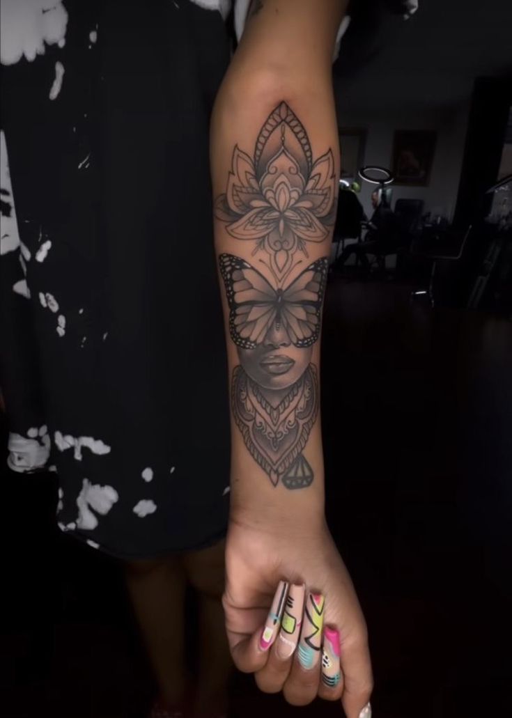 a woman's arm with a tattoo on it and a flower in the middle