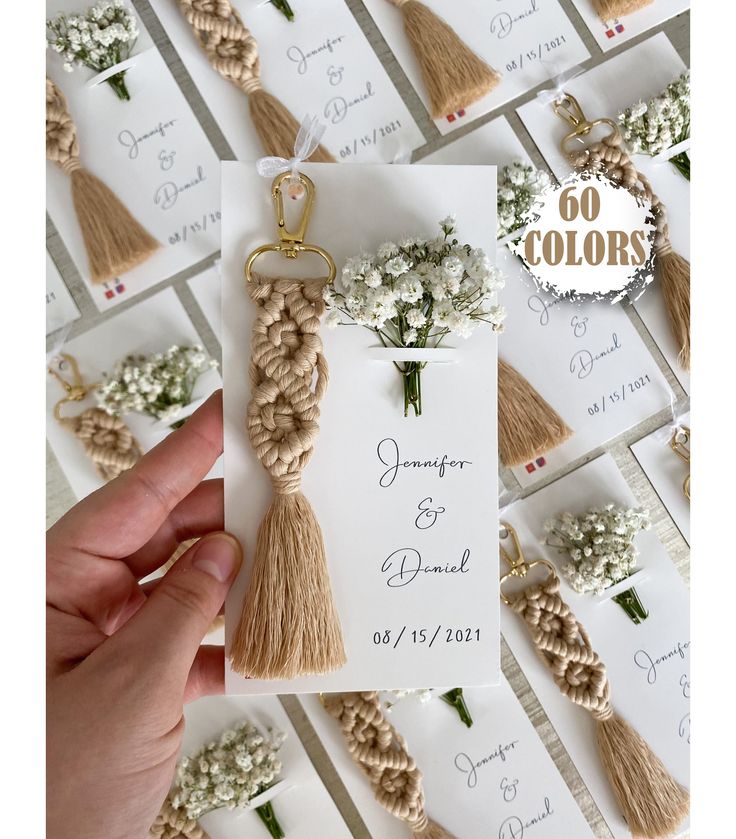 the wedding stationery is decorated with flowers and tassels for guests to use