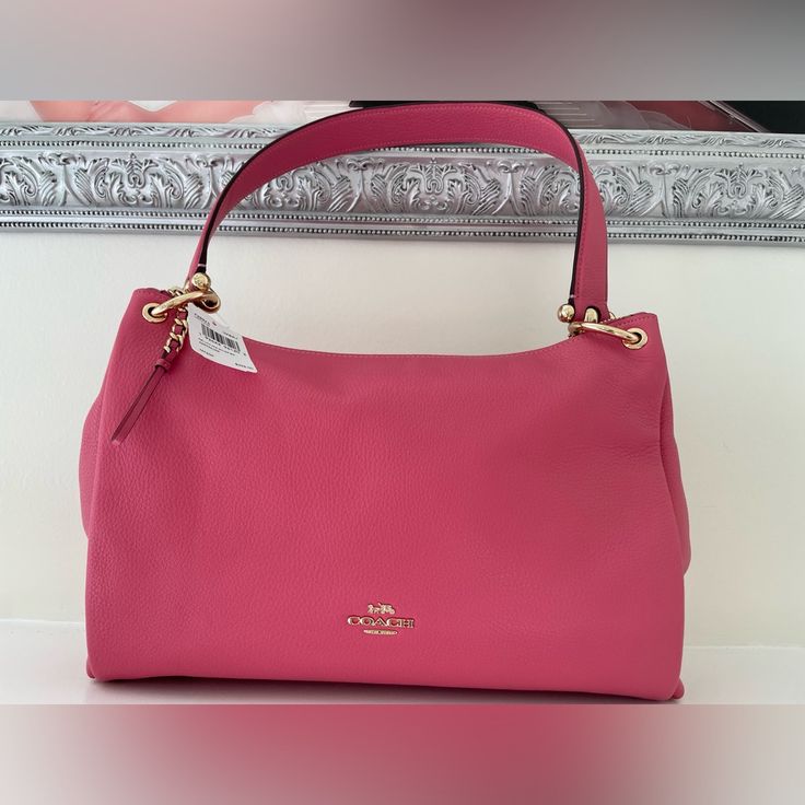 Coach Leather Shoulder Bag,Pink And Gold Hardware ,Interior Pink Fabric Lining With A Slip Pocket That Has Embossed Creed That Reads A1923-F28966 Gold Hardware In Exterior With Braided Gold Zipper ,Handle With 8 3/4”Drop Detachable Strap With 20”Drop For Shoulder Or Crossbody Wear Classic Pink Top Handle Satchel, Luxury Pink Leather Satchel, Classic Pink Satchel With Detachable Strap, Classic Pink Leather Bag, Classic Pink Shoulder Bag For Evening, Pink Soft Leather Rectangular Satchel, Pink Soft Leather Shoulder Bag, Pink Soft Leather Tote Satchel, Pink Soft Leather Satchel Bag