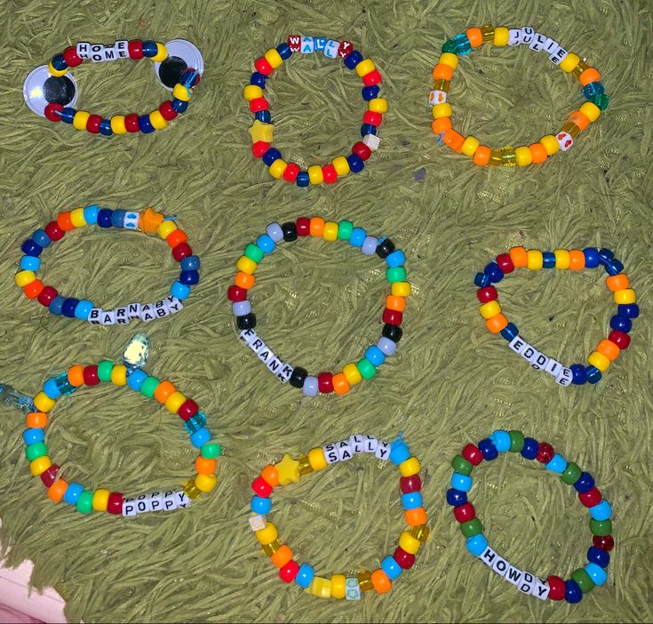 several bracelets that have been made out of plastic beads and are laying on the ground