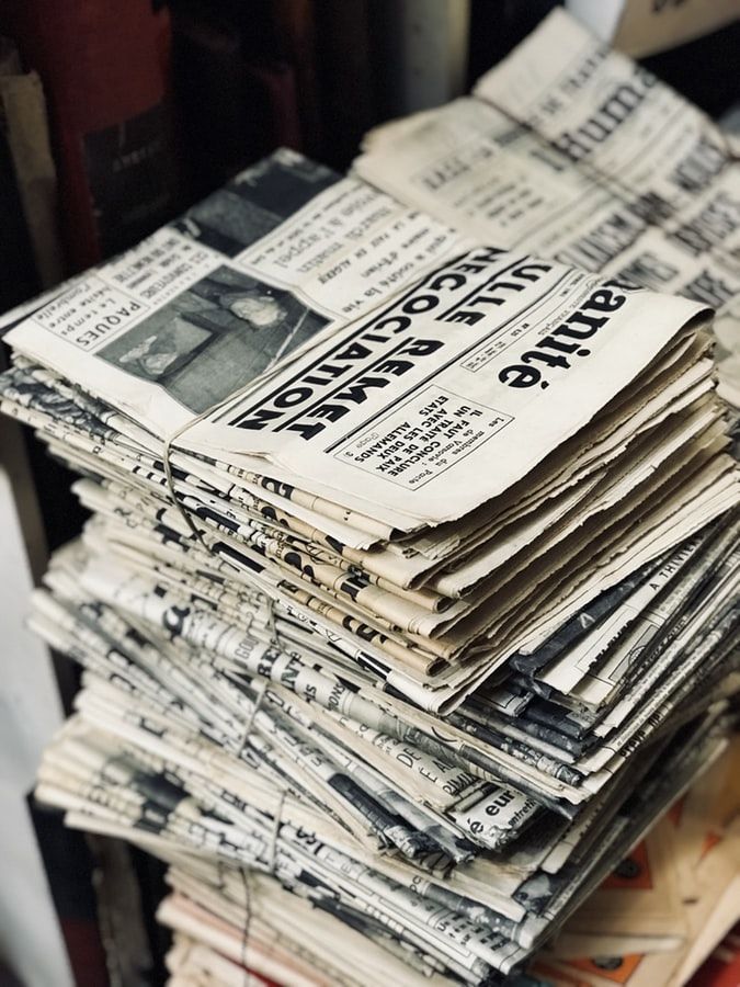 a stack of newspapers sitting on top of each other