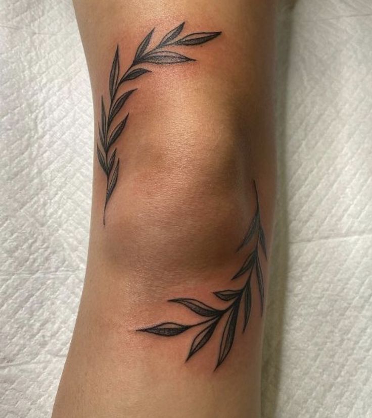 a close up of a person's leg with leaves on it