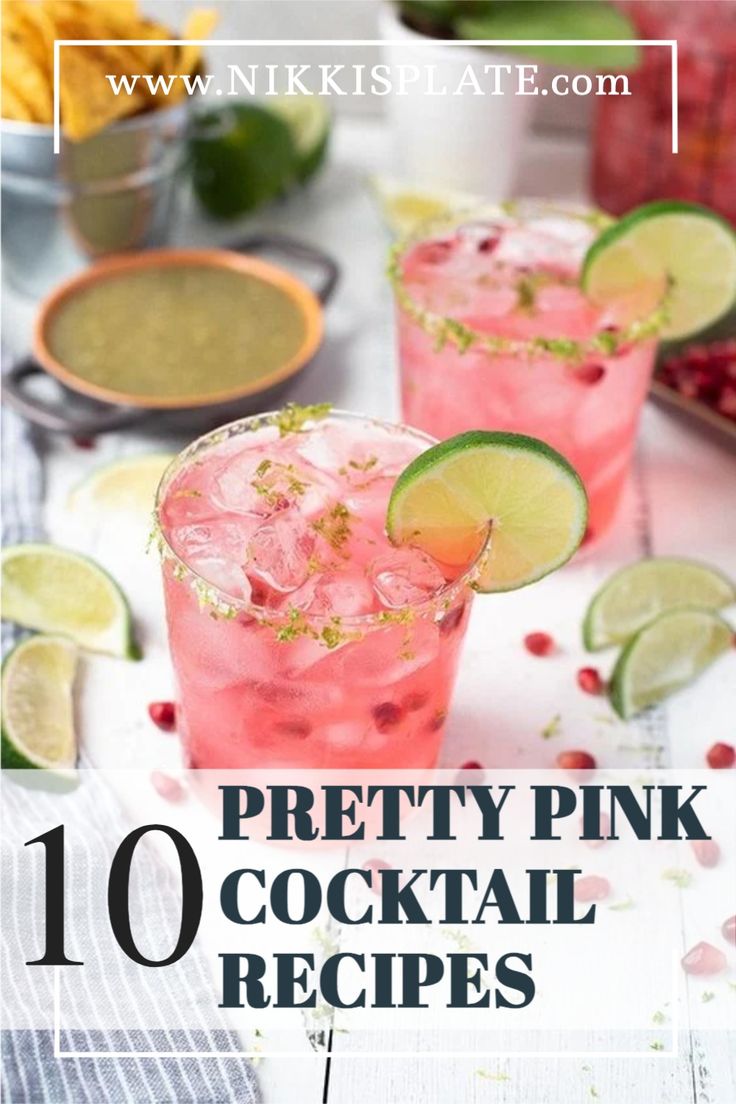 two pink cocktails with lime slices and garnish on the rim, surrounded by ingredients