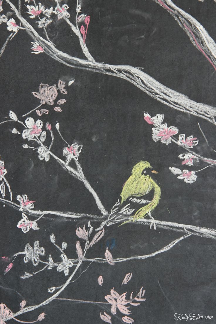 a drawing of a bird sitting on a tree branch with pink flowers in the background