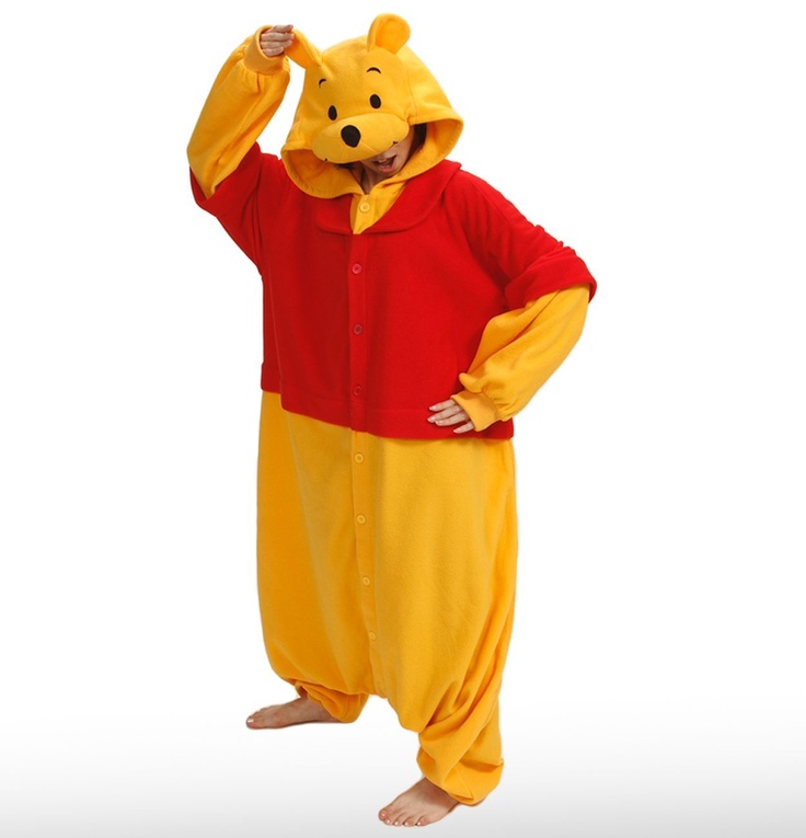 a man in winnie the pooh costume standing with his hands on his head and arms behind his head