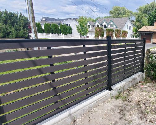 a black fence in front of some houses