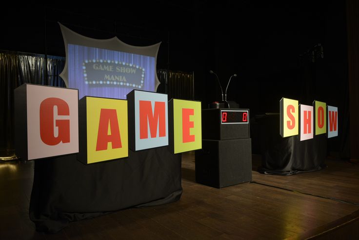 the stage is set up for a game show with speakers and signs that spell out games