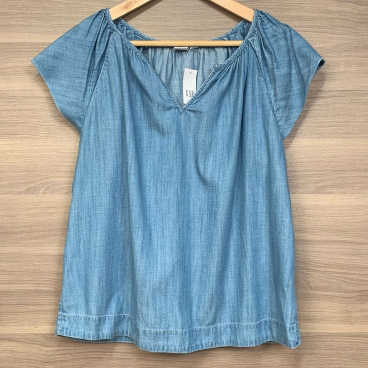 Nwt Blue Chambray Blouse, Short Sleeves, Loose Fit, Raglan Style, And V-Neck. Lyocell And Cotton Blend. Measurements Chest: 23” Length: 25” Comment With Questions No Trades Offers Welcome Through The Offer Feature Bundle And Save Even More! Can Ship In Two Days Max! Thanks For Shopping! Xoxo Amanda Ww8264 Medium Wash Denim V-neck Top, Light Wash V-neck Top For Day Out, Blue V-neck Denim Top For Summer, Gap Cotton Blouse, Gap V-neck Summer Tops, Medium Wash V-neck Top For Summer, Summer V-neck Top In Light Fabric, Fitted Medium Wash V-neck Tops, Medium Wash Fitted V-neck Top