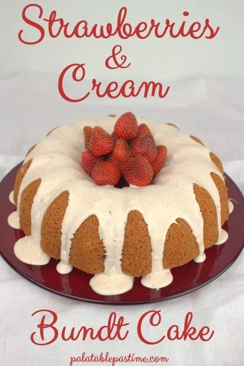 a bundt cake with strawberries and cream frosting on top, sitting on a red plate