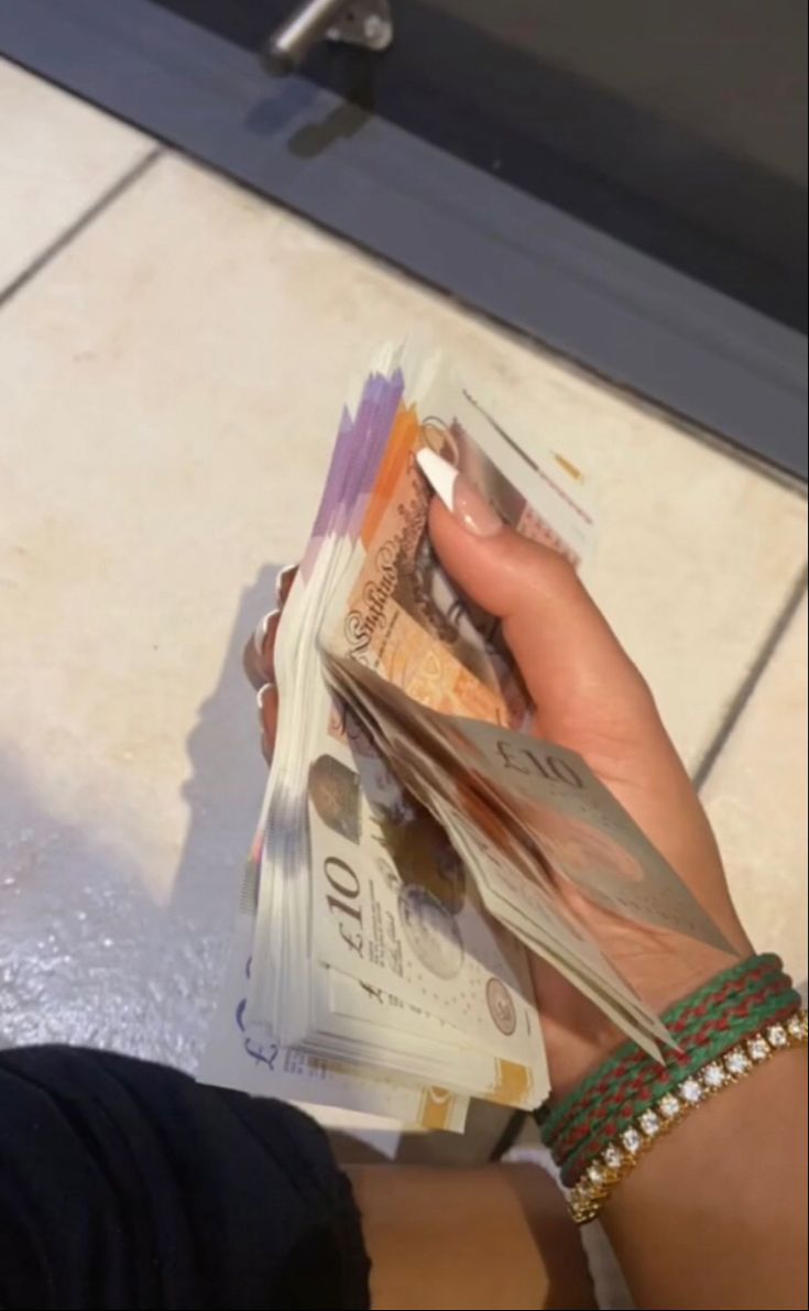 a woman is holding money in her hand