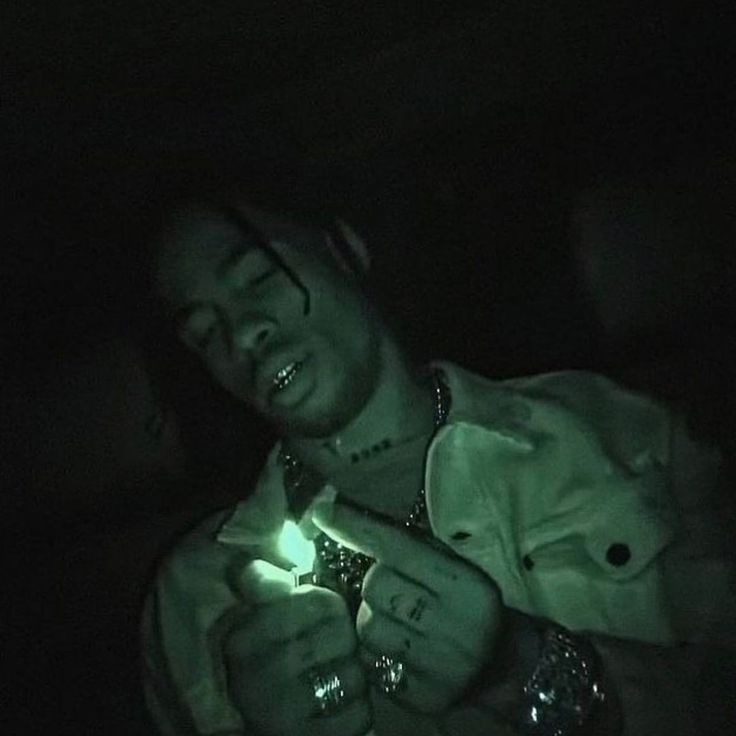 a man holding a lighter in the dark