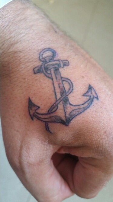 a hand with an anchor tattoo on it