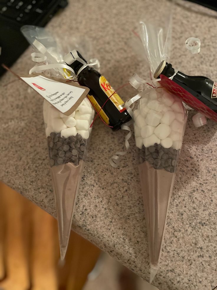 two bags filled with candy sitting on top of a counter next to a computer keyboard