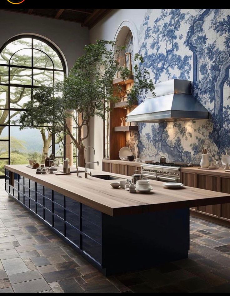 a large kitchen with blue and white wallpaper