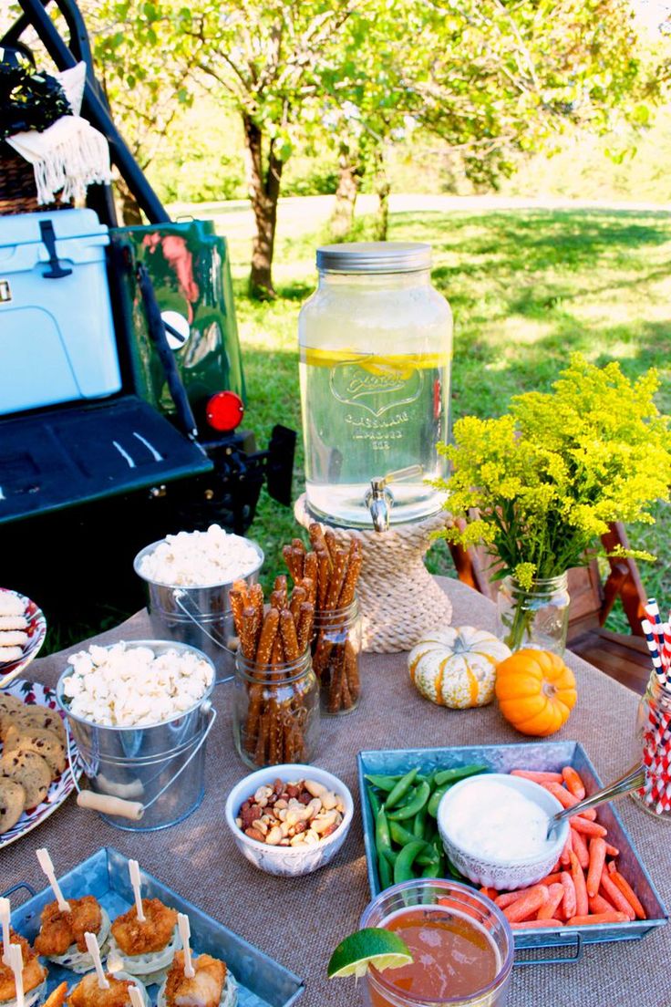 a picnic table with food and drinks on it