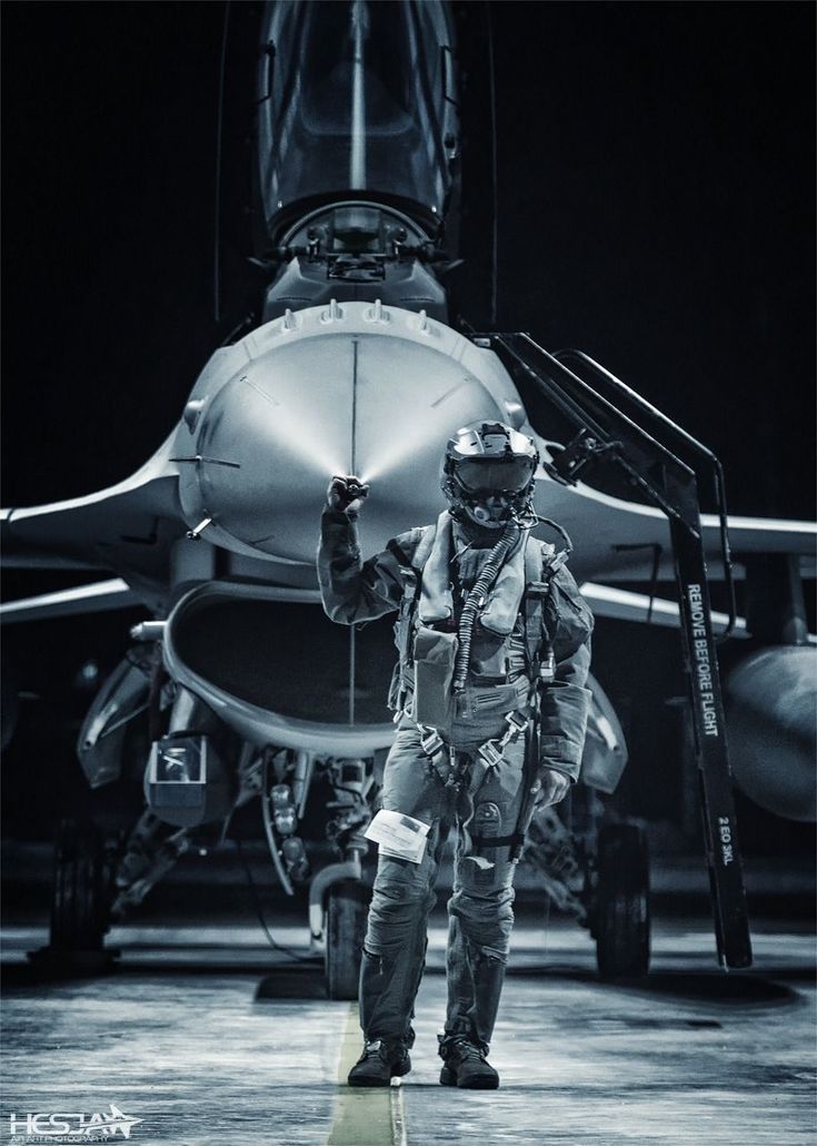 a man standing in front of an airplane