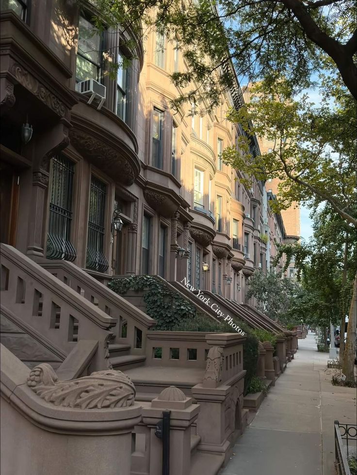 a row of brownstone townhouses on a city street