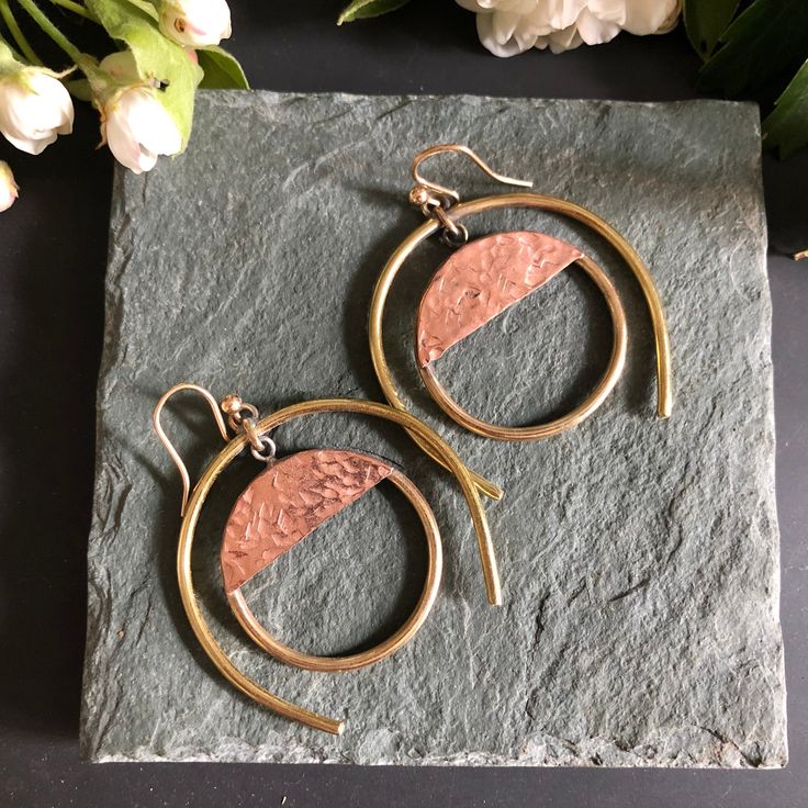 Hand formed brass & hammered copper. Finished with solid sterling silver earring wires.  Length ~ 2 inches Width ~ 1 3/4 inches Unique Hammered Hoop Earrings, Hammered Copper Hoop Jewelry, Hammered Copper Round Hoop Earrings, Artisan Electroformed Hoop Earrings, Unique Nickel-free Copper Hoop Earrings, Nickel-free Crescent Copper Jewelry, Handmade Modern Copper Jewelry, Modern Handmade Copper Jewelry, Modern Nickel-free Copper Jewelry