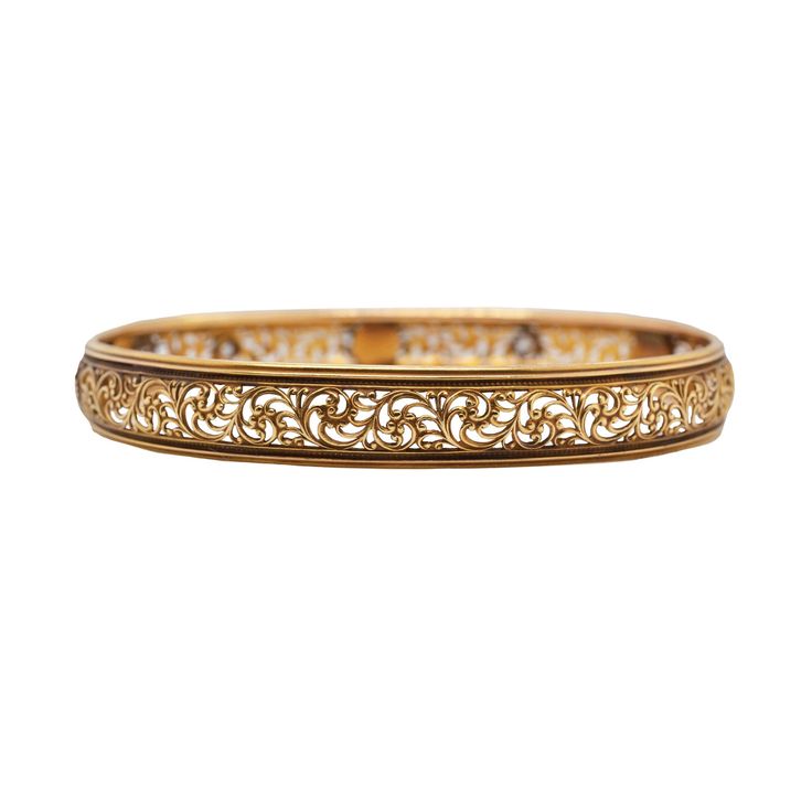 This ornate bangle bracelet features 0.20ctw of round old mine cut diamonds that are graded G-H in color, SI in clarity. Accented with additional vintage white pearls that bring a feminine touch to the old world scrollwork design that continues around the bangle. The bracelet measures 8" for an elegant, relaxed fit. Classic Gold Bangle With Intricate Design, Classic Gold Bangle Bracelet With Intricate Design, Classic Gold Bracelet With Intricate Design For Anniversary, Classic Ceremonial Bracelet With Intricate Design, Classic Gold Bracelet With Intricate Design, Elegant Gold Bracelet With Decorative Band, Antique Bangle With Intricate Design For Formal Occasions, Elegant Formal Bangle With Decorative Band, Victorian Bangle With Intricate Design For Formal Occasions