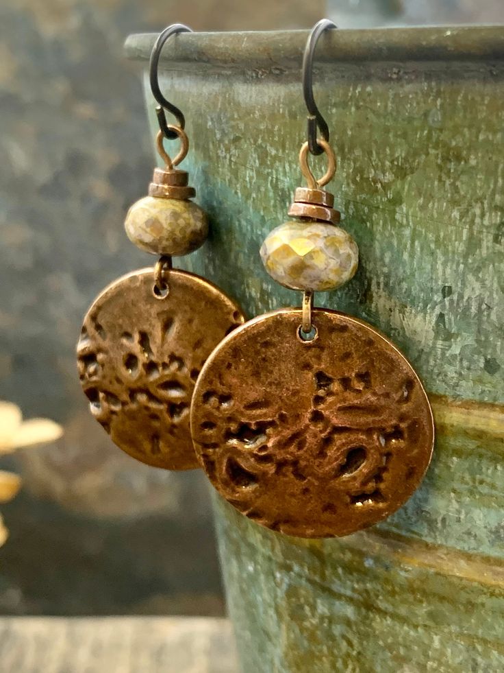 These are my handmade Copper Disc Earrings with earthy toned Czech glass beads. The copper metal discs are domed and have texture, with a very earthy tribal aesthetic, a bit Boho chic style. A great pair of everyday earrings! The ear-wires are hypoallergenic niobium wire, safer for sensitive ears. I create each piece of metal by hand, my jewelry is earthy, rustic, and organic with intentional artistic imperfections. No two pieces are exactly alike, creating truly one of a kind jewelry. ❤SIZE *7/ Earthy Bronze Dangle Jewelry, Rustic Nickel-free Round Bead Jewelry, Bohemian Brown Beaded Nickel-free Earrings, Adjustable Bronze Beaded Earrings As Gift, Gift Bronze Beaded Earrings, Nickel-free Brown Beaded Earrings With Czech Glass, Nickel-free Brown Czech Glass Beaded Earrings, Earthy Jewelry With Dangling Round Beads, Nature-inspired Jewelry With Dangling Beads For Gifts