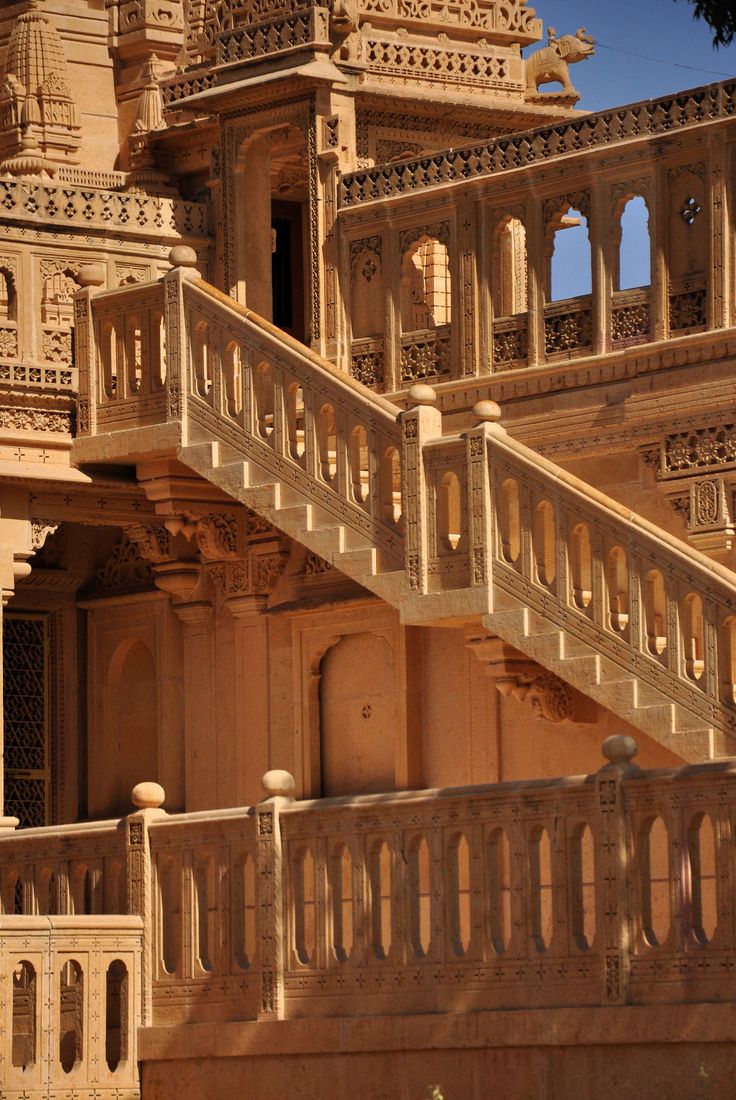 an intricately carved building with stairs and balconies