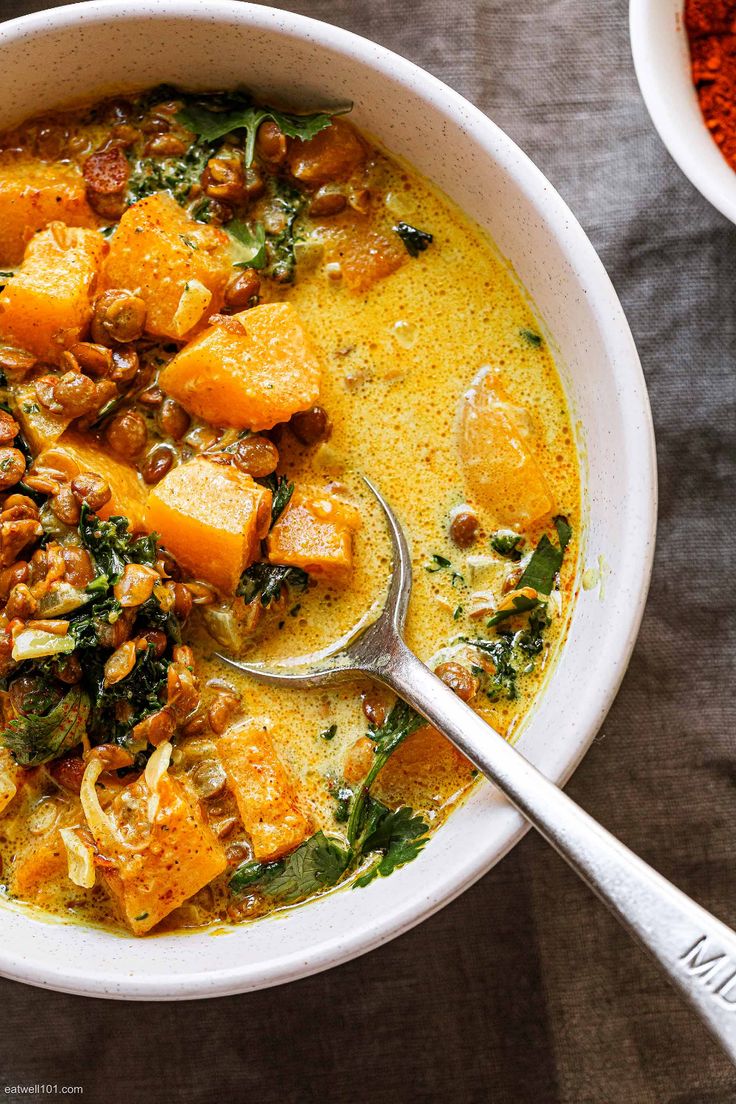 a white bowl filled with soup and vegetables