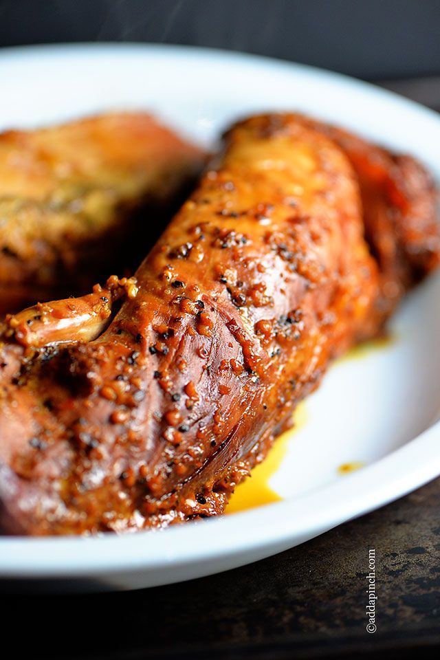 two pieces of meat sitting on top of a white plate