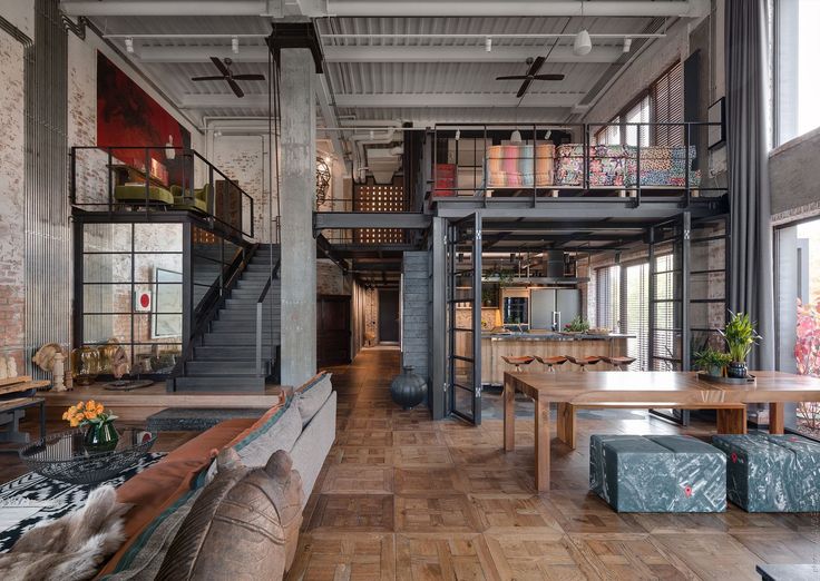 an industrial loft with exposed brick walls and wood flooring is pictured in this image